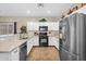 Modern kitchen with stainless steel appliances, white cabinets, and updated countertops at 1081 W Stephanie Ln, San Tan Valley, AZ 85143
