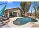 Inviting backyard pool featuring desert landscaping, outdoor seating, and a covered patio at 1081 W Stephanie Ln, San Tan Valley, AZ 85143