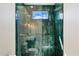 Custom shower featuring unique tiling, modern fixtures, and a glass door at 11143 E Onyx Ct, Scottsdale, AZ 85259