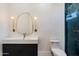 Well-lit bathroom with designer mirror and a shower with glass door at 11143 E Onyx Ct, Scottsdale, AZ 85259