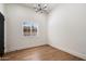 Bedroom featuring a window with wood-shutter blinds and hardwood flooring at 11143 E Onyx Ct, Scottsdale, AZ 85259