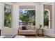 Bedroom seating area with a modern loveseat and views of the well-maintained backyard at 11143 E Onyx Ct, Scottsdale, AZ 85259