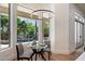 Cozy breakfast nook features modern lighting and picturesque views of the pool and backyard landscape at 11143 E Onyx Ct, Scottsdale, AZ 85259