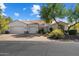 Inviting home featuring a tile roof, mature landscaping, and a convenient two-car garage at 11143 E Onyx Ct, Scottsdale, AZ 85259
