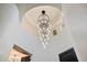Bright foyer showcases a modern chandelier and a unique, circular ceiling design at 11143 E Onyx Ct, Scottsdale, AZ 85259