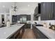 Spacious kitchen features gray cabinets, stainless steel appliances, and center island with a statement lighting fixture at 11143 E Onyx Ct, Scottsdale, AZ 85259