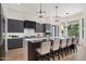 Modern kitchen with stainless appliances, center island, and designer lighting fixtures at 11143 E Onyx Ct, Scottsdale, AZ 85259