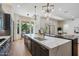 Open kitchen with an oversized island, designer fixtures and stainless steel appliances at 11143 E Onyx Ct, Scottsdale, AZ 85259