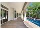 Covered patio with stone flooring overlooking backyard and swimming pool at 11143 E Onyx Ct, Scottsdale, AZ 85259