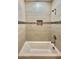 Bathroom showcasing a tub with tiled walls and a recessed shower niche at 11216 W Apache St, Avondale, AZ 85323