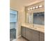 Bright bathroom with sleek vanity, ample storage, and modern fixtures at 11216 W Apache St, Avondale, AZ 85323