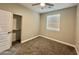 A bedroom featuring carpet, a window, and a closet at 11216 W Apache St, Avondale, AZ 85323