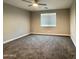 A view of a bedroom with carpet and a window at 11216 W Apache St, Avondale, AZ 85323