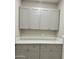 Storage area with gray cabinets with white countertops and silver hardware at 11216 W Apache St, Avondale, AZ 85323