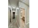 Hallway leads to a bathroom, with wood-look flooring and neutral paint at 11216 W Apache St, Avondale, AZ 85323