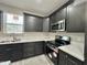 This kitchen is equipped with modern appliances, sleek cabinetry, and pristine white countertops at 11216 W Apache St, Avondale, AZ 85323