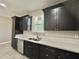 Bright kitchen features stainless steel appliances, dark cabinets, and a large window overlooking the sink at 11216 W Apache St, Avondale, AZ 85323