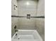 A full view of the shower which features a tile surround, a shower niche and a shower head at 11216 W Apache St, Avondale, AZ 85323
