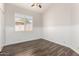 Light filled bedroom with wood-look tile, beadboard trim, and a window with white shutters at 1245 E Emile Zola Ave, Phoenix, AZ 85022