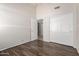 Bedroom showcasing wood-look tile flooring, a closet with white doors, and white trim at 1245 E Emile Zola Ave, Phoenix, AZ 85022