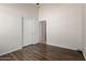 Bright bedroom with wood-look tile, neutral paint, and a closet with mirrored doors at 1245 E Emile Zola Ave, Phoenix, AZ 85022