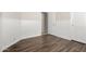 Bedroom with wood-look tile, beadboard trim, and access to an adjacent room at 1245 E Emile Zola Ave, Phoenix, AZ 85022