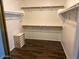 Walk in closet with wood floors and multiple shelving and racks at 1245 E Emile Zola Ave, Phoenix, AZ 85022