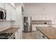 Bright kitchen featuring stainless steel refrigerator, granite countertops and white cabinetry at 1245 E Emile Zola Ave, Phoenix, AZ 85022
