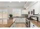 Kitchen with stainless steel appliances, granite counters, and bright, natural light at 1245 E Emile Zola Ave, Phoenix, AZ 85022