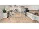 Modern kitchen featuring white cabinetry, granite countertops, and stainless steel appliances at 1245 E Emile Zola Ave, Phoenix, AZ 85022