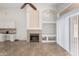 Comfortable living room with a cozy fireplace, built-in cabinets, and a sliding glass door at 1245 E Emile Zola Ave, Phoenix, AZ 85022