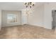 Spacious living room features tile floors, large window with natural light, and neutral walls at 1245 E Emile Zola Ave, Phoenix, AZ 85022