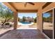 Covered patio offering an appealing view of the sparkling pool and backyard oasis on a sunny day at 1245 E Emile Zola Ave, Phoenix, AZ 85022