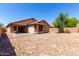 Expansive backyard with privacy wall, desert landscaping, and covered patio at 12838 W Desert Mirage Dr, Peoria, AZ 85383