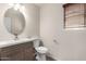 This bathroom features a round mirror and modern vanity at 12838 W Desert Mirage Dr, Peoria, AZ 85383