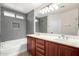 Modern bathroom with dual sink vanity, soaking tub, and a large vanity mirror at 12838 W Desert Mirage Dr, Peoria, AZ 85383