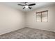 This bedroom features neutral carpet and a ceiling fan at 12838 W Desert Mirage Dr, Peoria, AZ 85383