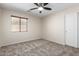This bedroom features neutral carpet and a window at 12838 W Desert Mirage Dr, Peoria, AZ 85383