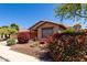 Charming home with colorful landscaping, a cozy bench, and a serene desert-scape design at 12838 W Desert Mirage Dr, Peoria, AZ 85383