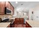 Open concept kitchen with stainless steel appliances, island, and access to an adjacent room at 12838 W Desert Mirage Dr, Peoria, AZ 85383