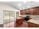 Well-equipped kitchen featuring stainless appliances, island, and attractive wood flooring at 12838 W Desert Mirage Dr, Peoria, AZ 85383