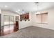 Open-concept living area showcasing neutral carpet, stylish lighting, and kitchen access at 12838 W Desert Mirage Dr, Peoria, AZ 85383