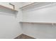 Well-lit walk-in closet with white walls, carpet and shelving for storage at 12838 W Desert Mirage Dr, Peoria, AZ 85383
