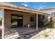 A covered back patio with string lights, an outdoor rug, and views of the serene yard at 1329 E Catalina Dr, Phoenix, AZ 85014