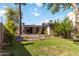 Well-maintained backyard with desert landscaping, including rocks, cacti, and a verdant lawn, creating a low-maintenance space at 1329 E Catalina Dr, Phoenix, AZ 85014
