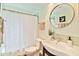 Well-lit bathroom with a modern round mirror and stylish vanity at 1329 E Catalina Dr, Phoenix, AZ 85014