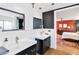 Beautiful bathroom featuring black and white decor, dual sinks and modern fixtures at 1329 E Catalina Dr, Phoenix, AZ 85014