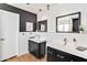 Modern bathroom with dual sinks, black accents and sleek white tile at 1329 E Catalina Dr, Phoenix, AZ 85014