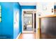 Bright foyer with a view of the front yard, featuring vibrant blue walls and modern decor at 1329 E Catalina Dr, Phoenix, AZ 85014