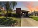Charming single-story home featuring a unique chimney design and covered parking, beautifully landscaped with lush greenery at 1329 E Catalina Dr, Phoenix, AZ 85014